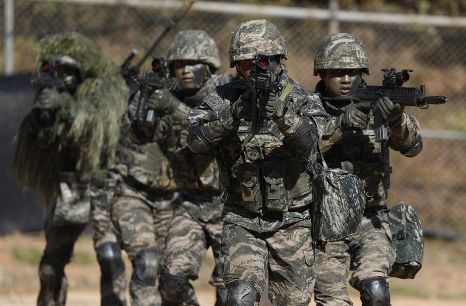 South Korean marines secure an area during their regular drill on Yeonpyeong Island, South Korea Thursday, Nov. 1, 2018. The U.S. and South Korea are reviewing whether they will conduct large-scale military exercises next year and will decide before December. South Korean Defense Minister Jeong Kyeong-doo told reporters Wednesday at the Pentagon that if more exercises are suspended the two countries will conduct other training to mitigate the lapse. He says the review will be done by Nov. 15. (Jeon Heon-kyun/Pool Photo via AP)