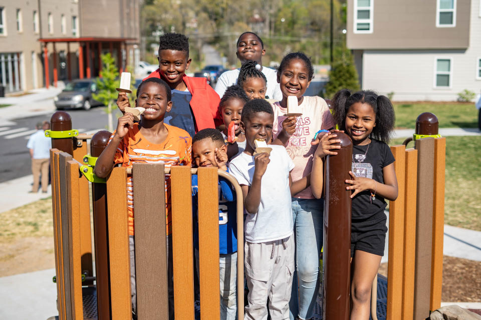 Children play at the dedication ceremony of Derrick Lee Jr. park at Maple Crest Apartments on April 22, 2022, Derrick's 16th birthday. Lee Jr. was killed nearby at the public housing neighborhood, formerly known as Lee Walker Heights.