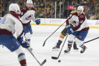 Colorado Avalanche right wing Brandon Duhaime (12) skates past Vegas Golden Knights center Ivan Barbashev (49) during the first period of an NHL hockey game Sunday, April 14, 2024, in Las Vegas. (AP Photo/Ian Maule)