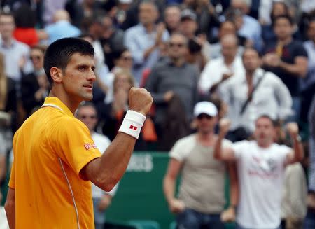 Novak Djokovic of Serbia reacts after defeating Rafael Nadal of Spain during their semi-final match at the Monte Carlo Masters in Monaco April 18, 2015. REUTERS/Jean-Paul Pelissier