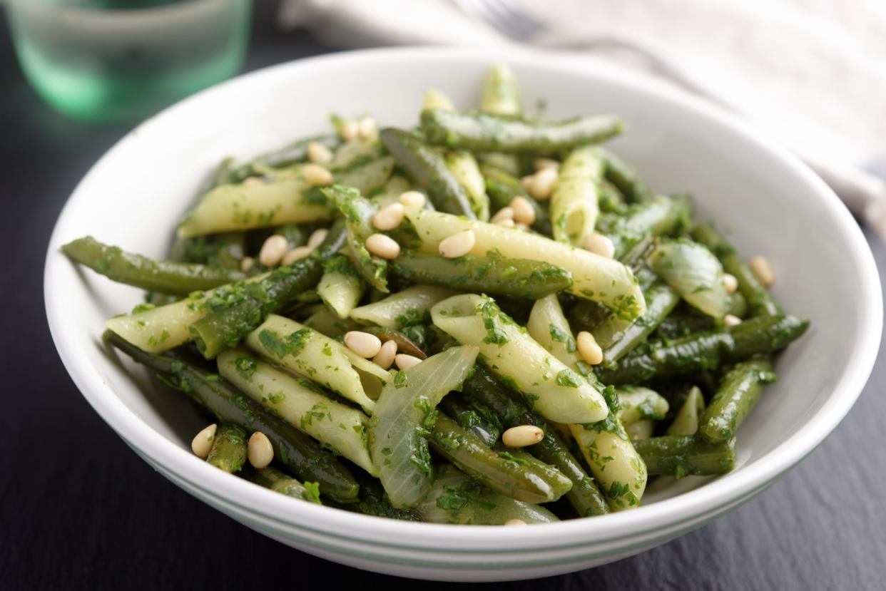 Pasta and green beans with pesto, basil and pine nuts