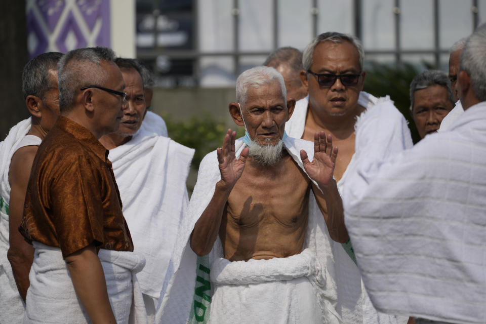 Husin bin Nisan, center, prays during a hajj rehearsal in Tangerang, Indonesia, Monday, May 15, 2023. After spending more than three decades picking tips from motorists, the 85-year-old volunteer traffic attendant is finally realizing his dream to go to the Islamic holy cities of Mecca and Medina for hajj pilgrimage. (AP Photo/Achmad Ibrahim)