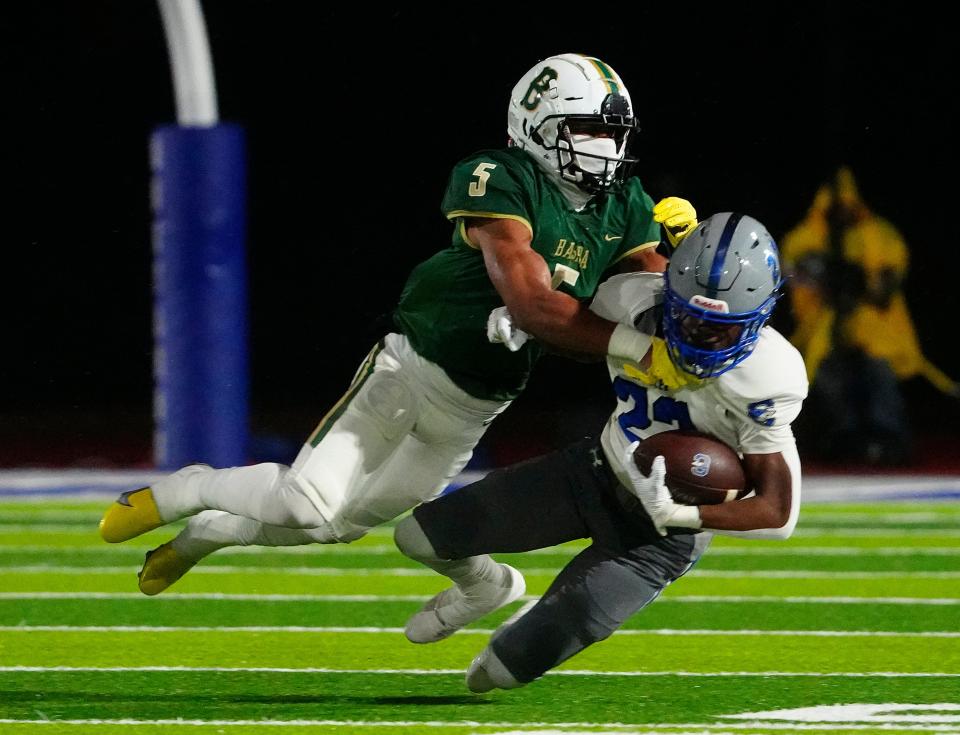 Chandler, Ariz; USA; Basha defensive back Cole Martin (5) tackles Chandler running back Ca'lil Valentine (22) during the Open Semfinal at Dobson High School.