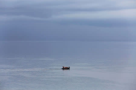 Rescue team members use a rubber boat during a search operation for the missing passengers after a ferry sank earlier this week in Lake Toba in Simalungun, North Sumatra, Indonesia, June 23, 2018. REUTERS/Beawiharta