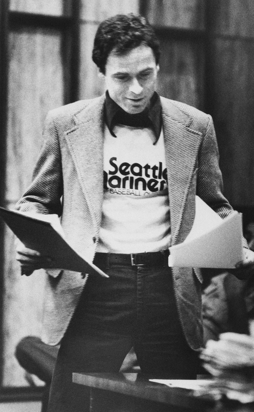 FILE - In this July 5, 1979 file photo, accused serial killer Ted Bundy wears a Seattle Mariners T-shirt in court in Miami, as he presents is own motions and made a request for a typewriter in his Dade County jail cell. The judge denied Bundy's request saying that Bundy's handwriting is perfectly legible. The defendant is acting as his own attorney although there are others on his defense team. (AP Photo)