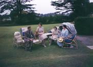 <p>King George VI, Queen Elizabeth, Princess Elizabeth and Princess Margaret relax as a family in the summer sun at the Royal Lodge in Windsor.</p>