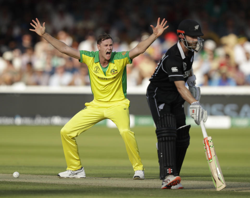 Australia's Jason Behrendorff celebrates after getting New Zealand's Martin Guptill out lbw, as New Zealand's captain Kane Williamson returns to his crease, during the Cricket World Cup match between New Zealand and Australia at Lord's cricket ground in London, Saturday, June 29, 2019. (AP Photo/Matt Dunham)