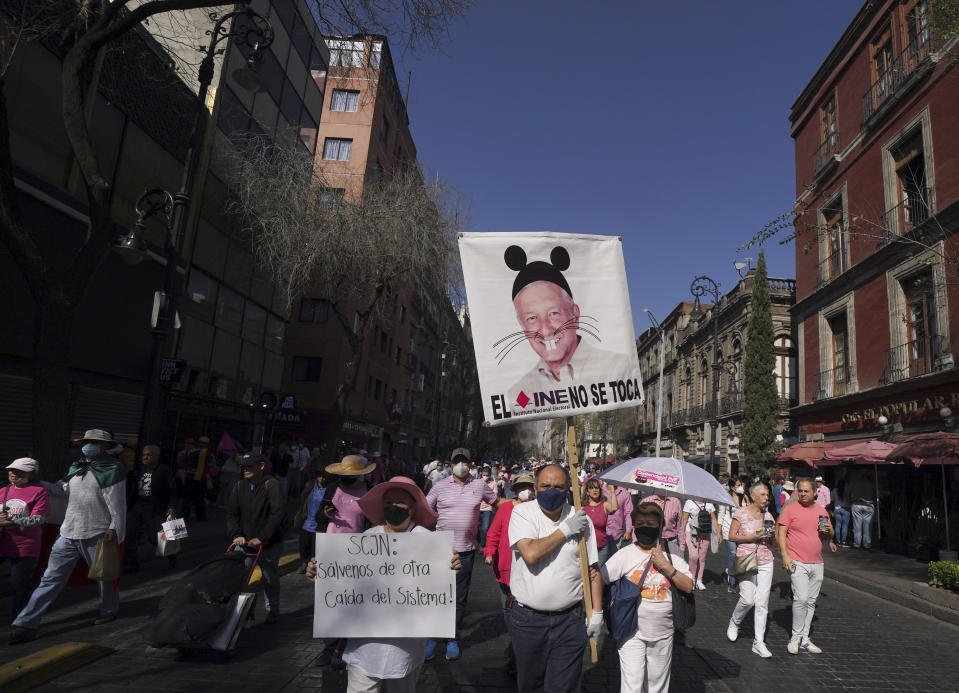 Anti-government demonstrators march against recent reforms pushed by President Andres Manuel Lopez Obrador to the country's electoral law that they say threaten democracy, towards Mexico City's main square, The Zocalo, Sunday, Feb. 26, 2023. (AP Photo/Fernando Llano)