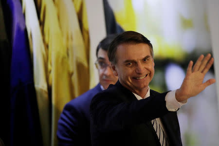 Brazil's President Jair Bolsonaro waves at an inauguration ceremony of the new president of the Parliamentary Agricultural Front (FPA) in Brasilia, Brazil February 19, 2019. REUTERS/Ueslei Marcelino