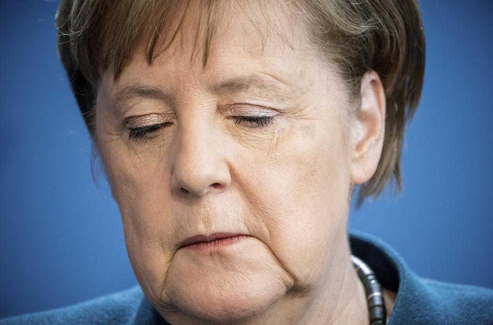 German Chancellor Angela Merkel speaks at a press conference about coronavirus, in Berlin, Sunday, March 22, 2020. German Chancellor Angela Merkel has gone into quarantine after being informed that a doctor who administered a vaccine to her has tested positive for the new coronavirus.Merkel's spokesman said the German chancellor was informed about the doctor's test shortly after holding a news conference Sunday announcing new measures to curb the spread of the virus. For most people, the new coronavirus causes only mild or moderate symptoms. For some it can cause more severe illness. (Michael Kappeler/Pool photo via AP)