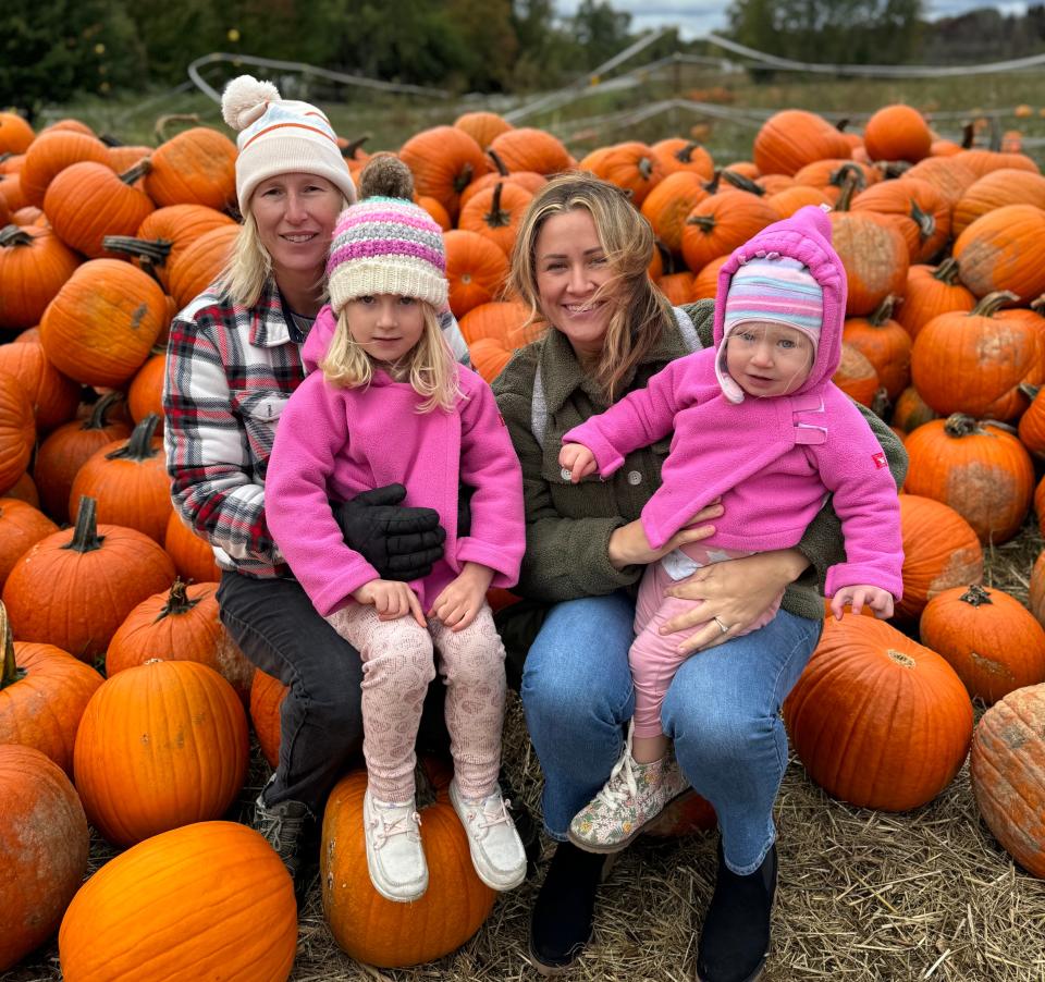 MSU women's tennis coach Kim Bruno, left, with her family last fall, including wife Shayna and daughters Blakely, left, and Avery, right.