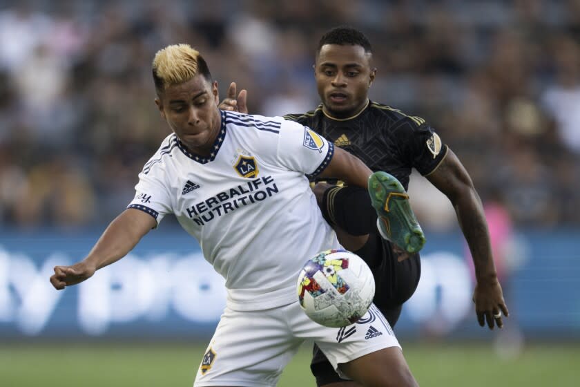 LA Galaxy midfielder Efrain Alvarez, left, and Los Angeles FC defender Diego Palacios.