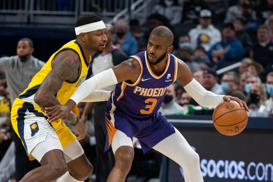 Jan 14, 2022; Indianapolis, Indiana, USA; Phoenix Suns guard Chris Paul (3) dribbles the ball while Indiana Pacers forward Torrey Craig (13) defends in the first half at Gainbridge Fieldhouse. Mandatory Credit: Trevor Ruszkowski-USA TODAY Sports