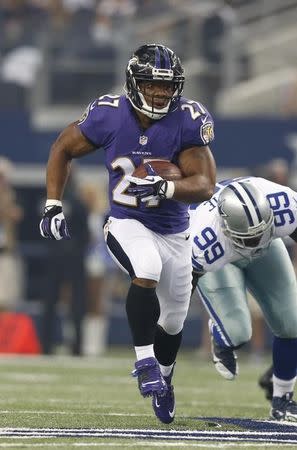 Baltimore Ravens running back Ray Rice (27) runs with the ball in the second quarter against Dallas Cowboys defensive end George Selvie (99) at AT&T Stadium. Mandatory Credit: Matthew Emmons-USA TODAY