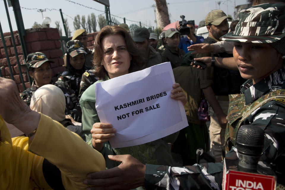 Safia Abdullah, daughter of Jammu and Kashmir National Conference leader Farooq Abdullah, holds a placard during a protest in Srinagar, Indian controlled Kashmir, Tuesday, Oct. 15, 2019. A small group of women under the banner of ‘Women of Kashmir’, a civil society group had gathered for a peaceful protest to condemn Indian government downgrading the region's semi-autonomy and demanded restoration of civil liberties and fundamental rights of citizens. (AP Photo/Dar Yasin)