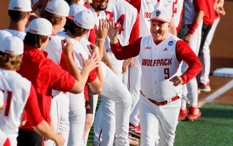 N.C. State head coach Elliott Avent greets his players during team introductions before N.C. State’s game against Bryant in the NCAA Raleigh Regional at Doak Field Friday, May 31, 2024.