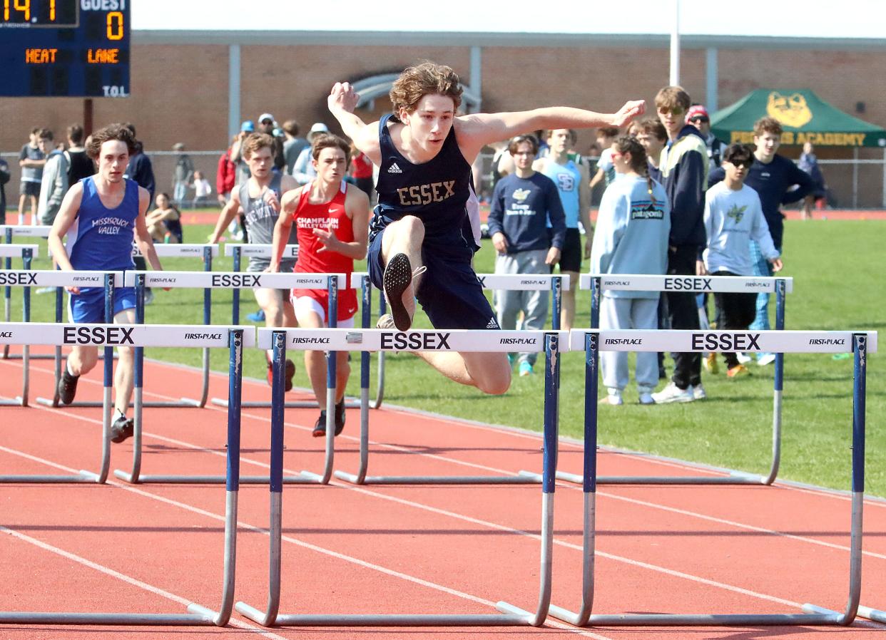 Max Lesny of Essex clears a hurdle during the boys 110 meter hurdle race at the 2023 Essex Vocational track and field meet.