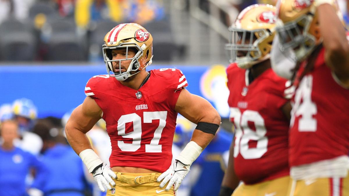 San Francisco 49ers first-round pick Nick Bosa, center, holds up a jersey  next to his mother Cheryl, left, and father John during an NFL football  news conference, Friday, April 26, 2019, in