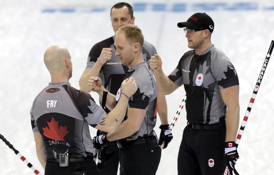 Canada's men's curling team as seen from left to right, Ryan Fry, E.J. Harnden, Brad jacobs and Ryan Harnden celebrate after beating China in the men's curling semifinal game at the 2014 Winter Olympics, Wednesday, Feb. 19, 2014, in Sochi, Russia. (AP Photo/Wong Maye-E)