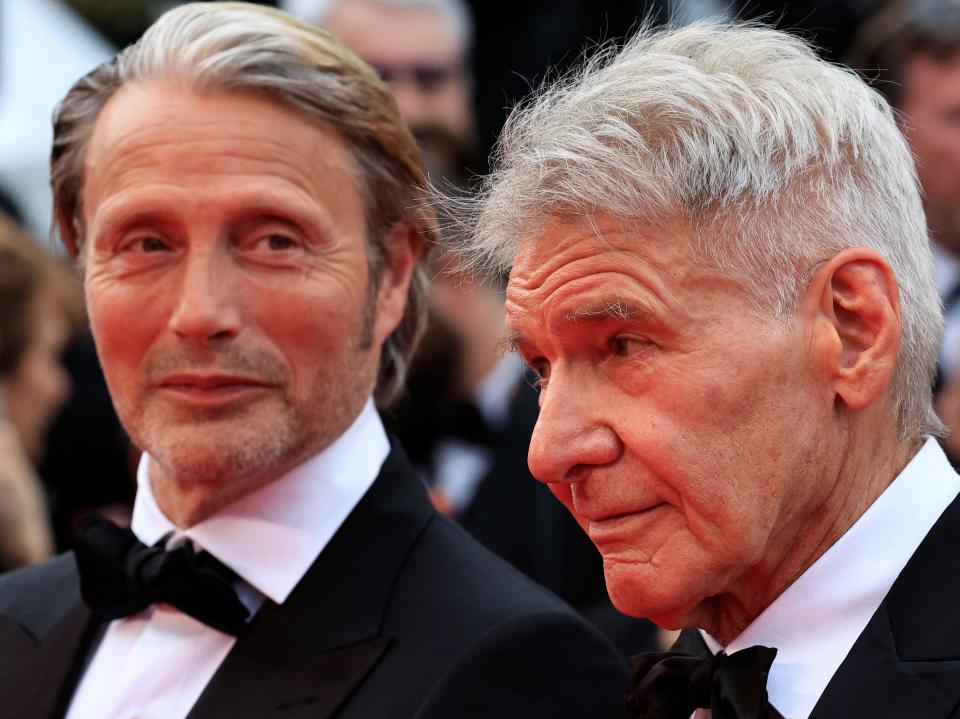 Mads Mikkelsen looking at Harrison Ford