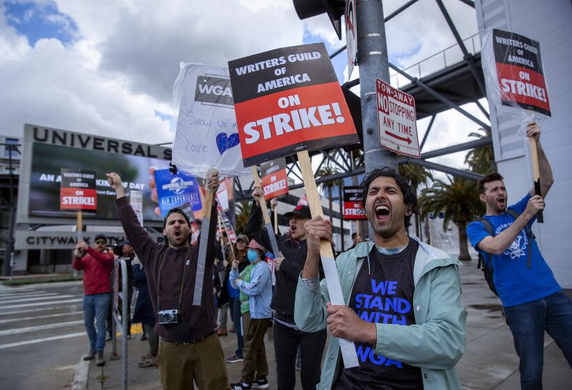UNIVERSAL CITY, CA-MAY 4, 2023:Cheech Manohar, 2nd from right, a writer and actor, strikes with other members of the Writers Guild of America outside of NBC/Universal Studios in Universal City. (Mel Melcon / Los Angeles Times)