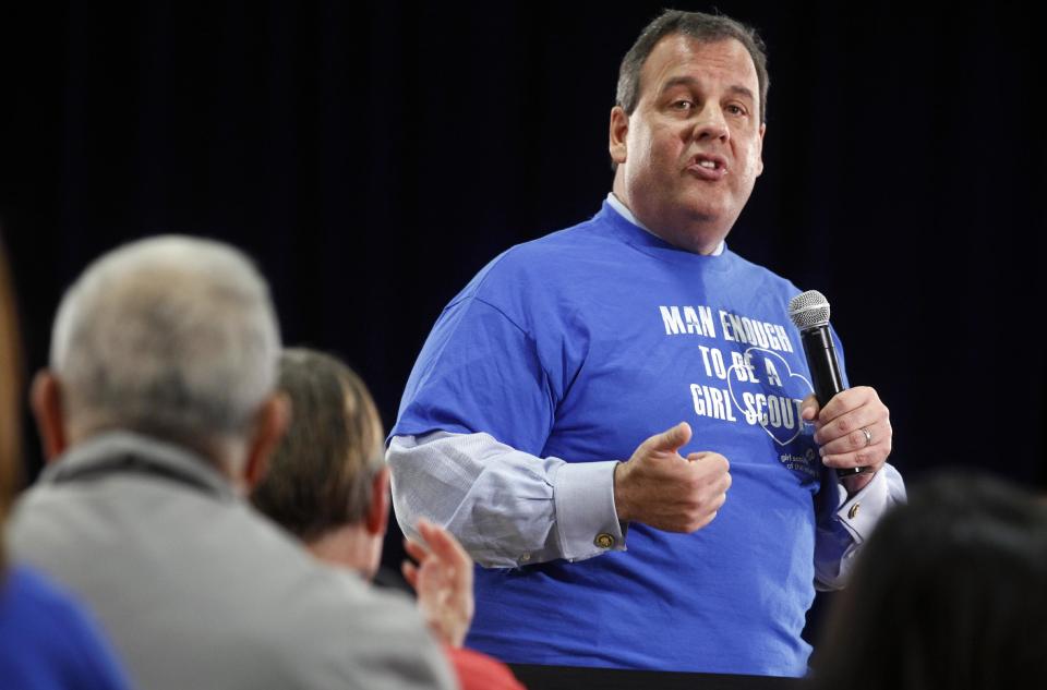 New Jersey Gov. Chris Christie wears a girl scout shirt given to him by a supporter during a town hall meeting in Brick Township, N.J., Thursday, April 24, 2014. (AP Photo/Mel Evans)