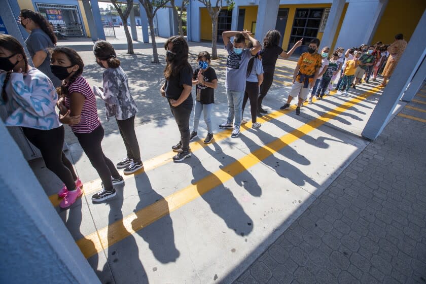 SOUTH GATE, CA - August 16: Second graders wait in line for a snack on the first day of school at Los Angeles Unified School District at Montara Avenue Elementary School Monday, Aug. in South Gate, CA. Los Angeles Unified Interim Superintendent Megan K. Reilly, Board Members and special guests celebrate the first day of instruction on August 16, welcoming students, teachers, principals, school site employees and families, while visiting special programs and classrooms at each site. (Allen J. Schaben / Los Angeles Times)