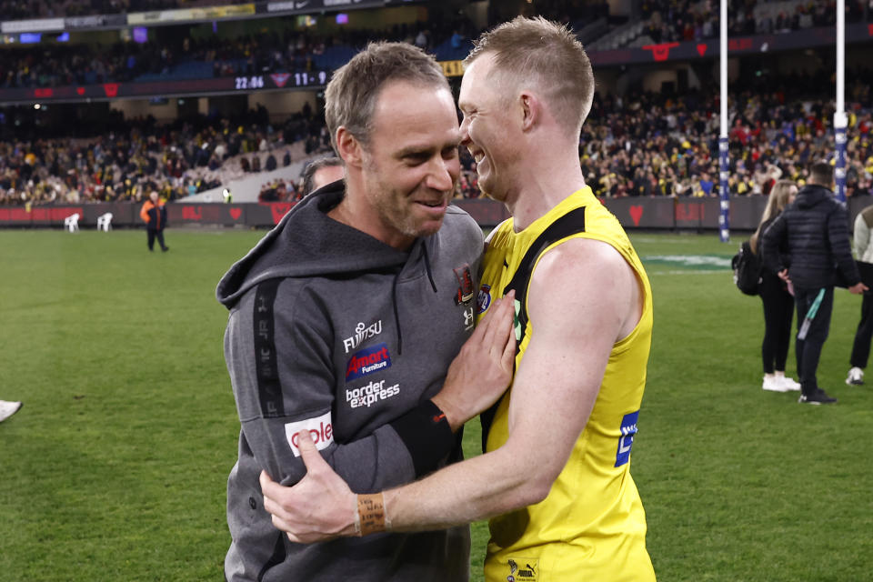 Ben Rutten (pictured left) and Tigers player Jack Riewoldt (pictured right) embrace.