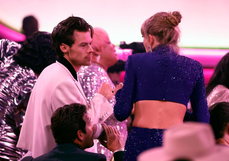 Harry Styles and Taylor Swift speak during the Grammy Awards Sunday in Los Angeles.