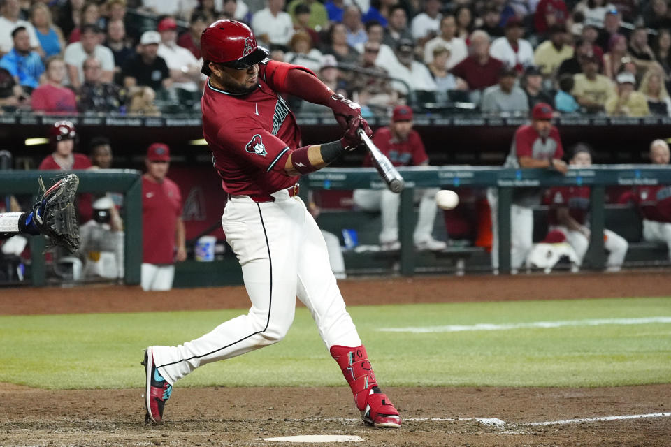 Arizona Diamondbacks' Eugenio Suárez connects for a two-run single against the Toronto Blue Jays during the fifth inning of a baseball game, Sunday, July 14, 2024, in Phoenix. (AP Photo/Ross D. Franklin)