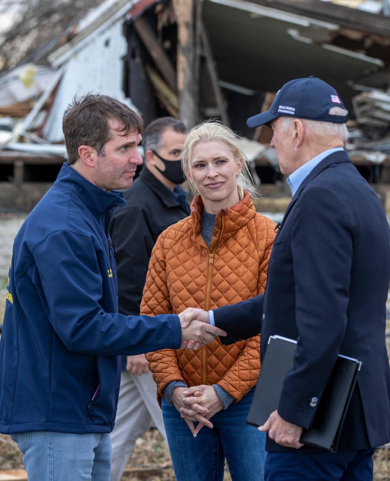 Gov. Andy Beshear shakes hands with Pres. Joe Biden and thanks him for a promise of federal aid as Biden toured the tornado devastation in Dawson Springs, Ky. on Wednesday evening. Dec. 15, 2021