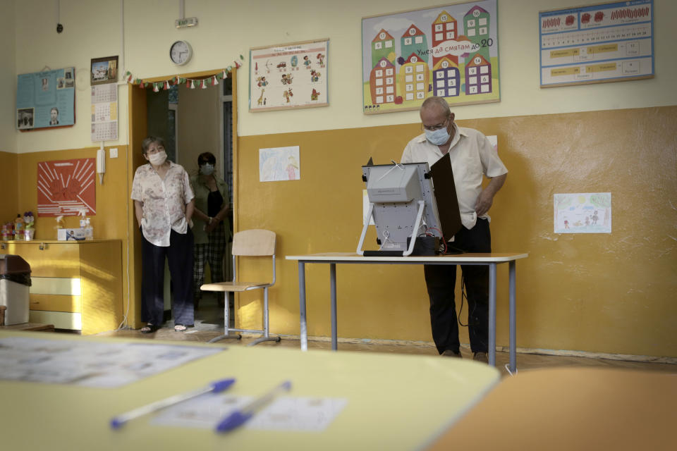 A man votes in Sofia, Sunday, July 11, 2021. Bulgarians are voting in a snap poll on Sunday after a previous election in April produced a fragmented parliament that failed to form a viable coalition government. (AP Photo/Valentina Petrova)