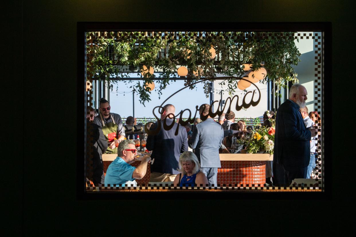 The bar at Soprana Rooftop Cucina is seen through a window, April 18, 2024.