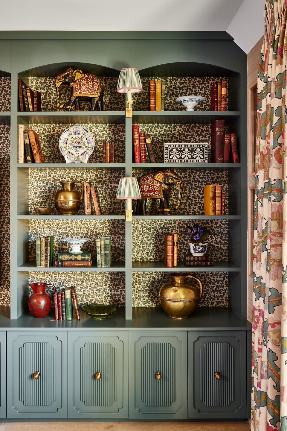 a shelf with chinaware and vases