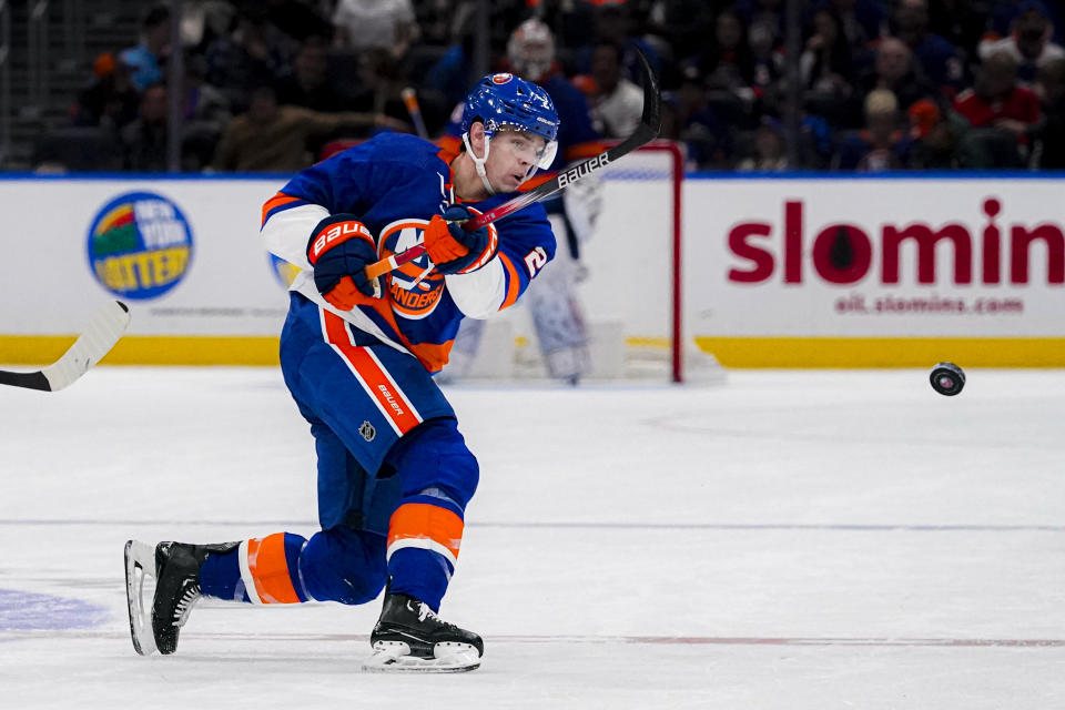 New York Islanders defenseman Mike Reilly passes the puck during the second period of an NHL hockey game against the Washington Capitals in Elmont, N.Y., Friday, Dec. 29, 2023. (AP Photo/Peter K. Afriyie)