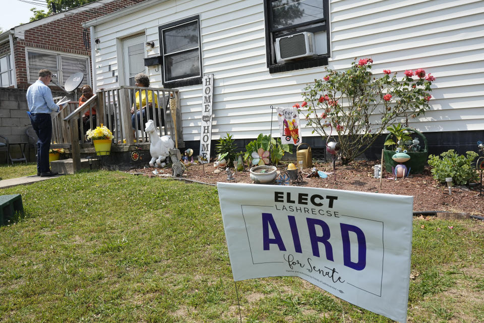 Virginia state Sen. Joe Morrissey, left, talks with constituents as he canvases a neighborhood, Monday, May 22, 2023, in Petersburg, Va. Morrissey is being challenged in a Democratic primary for a newly redrawn senatorial district by former Delegate Lashrecse Aird. (AP Photo/Steve Helber)