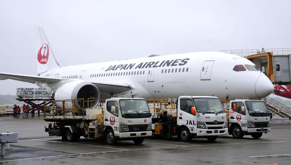 A plane waits on tarmac for loading the cargos before its departure for Taiwan, at Narita International Airport in Narita, east of Tokyo, Friday, June 4, 2021. Japan is donating 1.24 million doses of AstraZeneca vaccine to Taiwan to help the island fight its latest resurgence of the COVID-19 cases, as Tokyo, despite its painfully slow vaccine rollouts at home, tries to play a greater role in global vaccination distribution.(Sadayuki Goto/Kyodo News via AP)