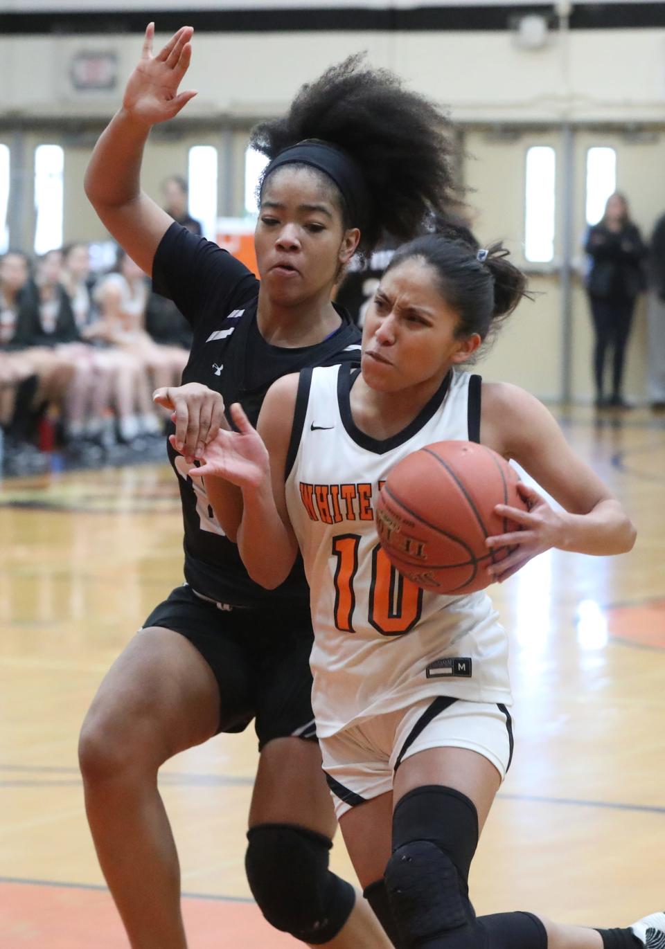 White Plains' Ineivi Plata is pressured by New Rochelle's Skye Presley during a Section 1 Class AA quarterfinal at Mamaroneck Feb. 24, 2023. White Plains won 65-42.