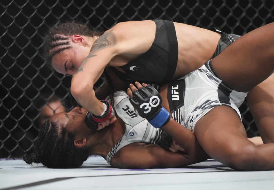 Diana Belbita, top, and Maria Oliveira fight during a women's strawweight bout at UFC 289 in Vancouver, British Columbia on Saturday, June 10, 2023. (Darryl Dyck/The Canadian Press via AP)