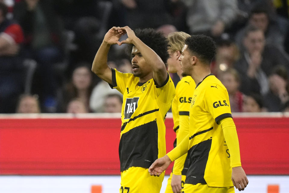 Dortmund's Karim Adeyemi, left, celebrates with teammates after scoring his side's opening goal during the German Bundesliga soccer match between FC Bayern Munich and Borussia Dortmund at the Allianz Arena stadium, in Munich, Germany, Saturday, March 30, 2024. (AP Photo/Matthias Schrader)