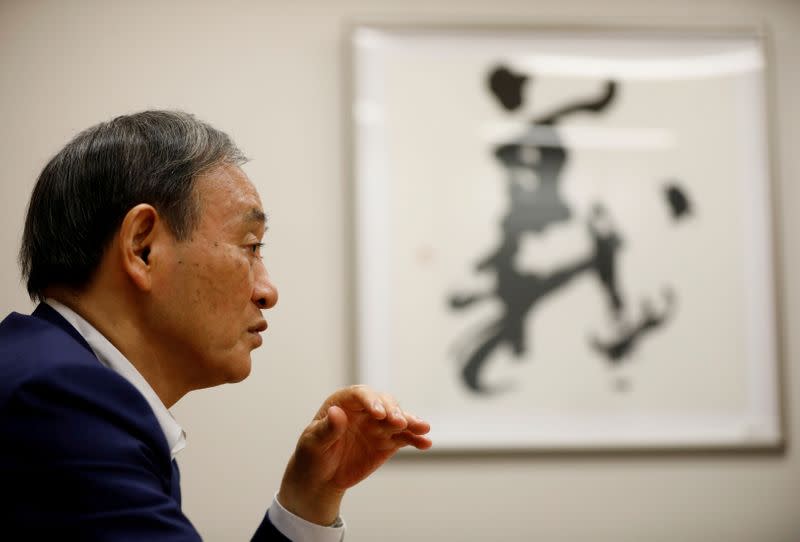 FILE PHOTO: Japan's top government spokesman Chief Cabinet Secretary Yoshihide Suga speaks during an interview with Reuters in Tokyo