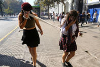 Demonstrators react to the effects of tear gas during a protest calling for changes in the education system in Santiago, Chile April 11, 2017. REUTERS/Ivan Alvarado