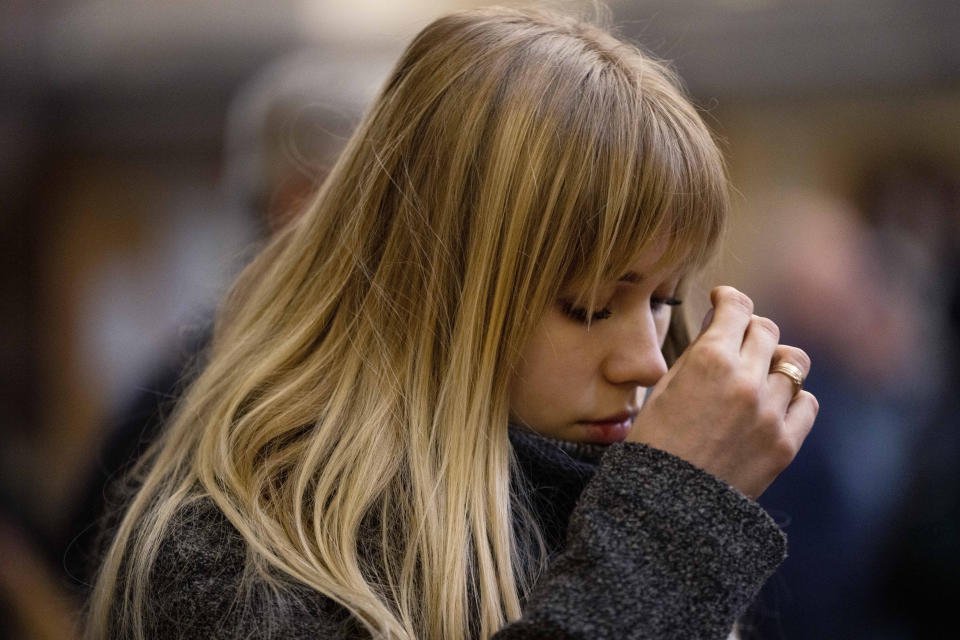 CORRECTS TO SERVICE, NOT MASS - A woman prays during a service at the Holy Eucharist Church, a day after Russian rockets hit an oil facility and factory in an industrial area, in Lviv, western Ukraine, Sunday, March 27, 2022. (AP Photo/Nariman El-Mofty)