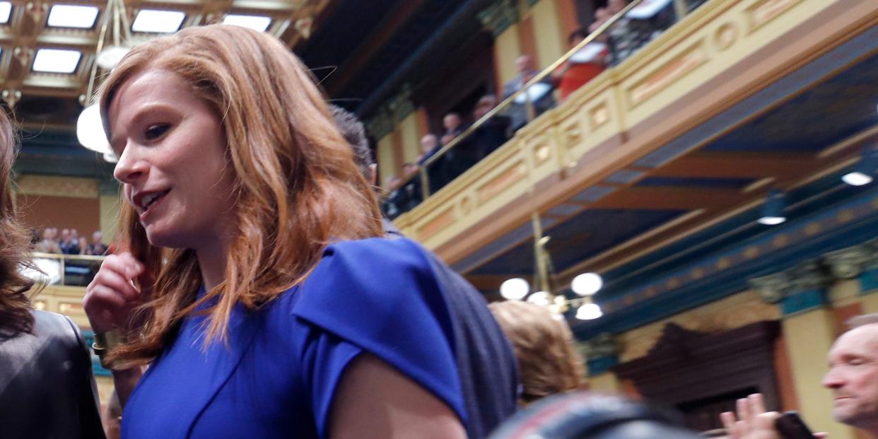 Michigan Gov. Gretchen Whitmer, center, is escorted by state Rep. Frank Liberati, left, and state Sen. Mallory McMorrow before delivering her State of the State address in 2020.