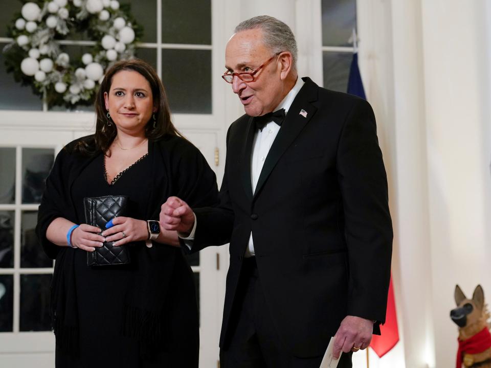 Senate Majority Leader Chuck Schumer of N.Y., speaks to members of the media as he arrives with his daughter Jessica Schumer for the State Dinner with President Joe Biden and French President Emmanuel Macron at the White House in Washington, Thursday, Dec. 1, 2022.