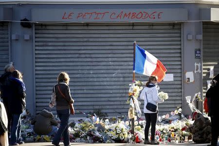 People mourn outside "Le Petit Cambodge" restaurant a week after a series of deadly attacks in the French capital Paris, France, November 22, 2015. REUTERS/Charles Platiau