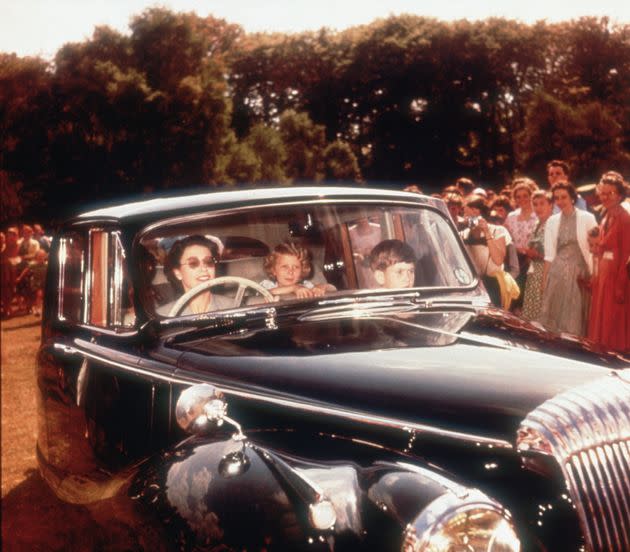 Queen Elizabeth II driving a Daimler saloon car with Prince Charles and Princess Anne as passengers, circa 1957. (Photo: Hulton Archive/Getty Images)