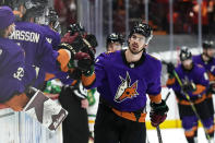 Arizona Coyotes right wing Conor Garland (83) celebrates with teammates after scoring a goal against the Minnesota Wild in the third period during an NHL hockey game, Saturday, March 6, 2021, in Glendale, Ariz. (AP Photo/Rick Scuteri)