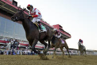 Jose Ortiz, left, atop Early Voting, edges out Joel Rosario, second from right, atop Epicenter, and Brian Hernandez Jr., right, atop Creative Minister, to win during the 147th running of the Preakness Stakes horse race at Pimlico Race Course, Saturday, May 21, 2022, in Baltimore. (AP Photo/Julio Cortez)