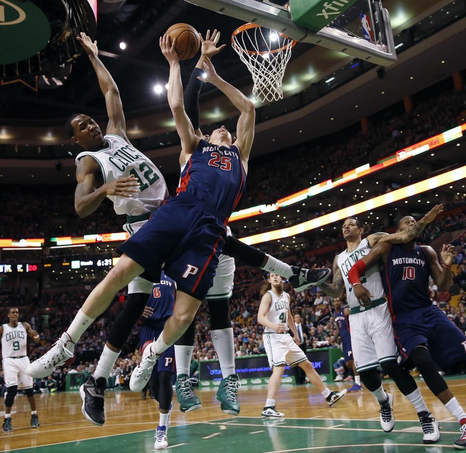 Detroit Pistons' Kyle Singler (25) loses control of the ball in front of Boston Celtics' Chris Johnson (12) in the first quarter of an NBA basketball game in Boston, Sunday, March 9, 2014. (AP Photo/Michael Dwyer)